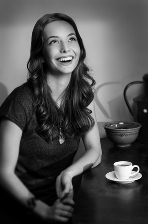 Vintage style portrait of gorgeous brunette with cup of espresso.の写真素材