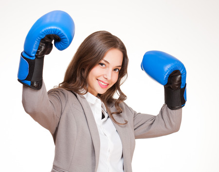 Portrait of young brunette beauty in blue boxing gloves.の写真素材