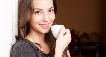 Portrait of a gorgeous young brunette woman having coffee.の写真素材