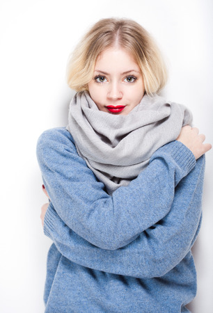 Portrait of a blond woman in warm winter clothes.の写真素材