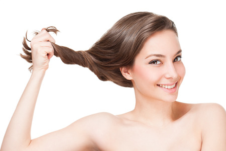 Portrait of a gorgeous young brunette woman with healthy hair.の写真素材