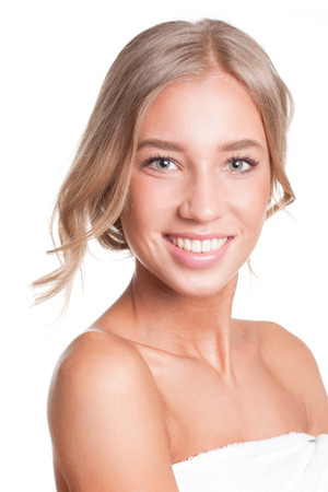 Portrait of a gorgeous young blond woman in bathing towel.の写真素材