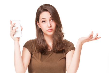 Portrait of a sweet young brunette using mobile phone.の写真素材