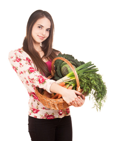 Portrait of cute young brunette with a basket of healthy groceries.の写真素材