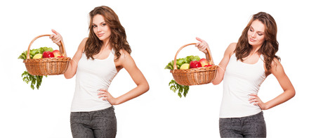 Gorgeous young brunette woman with a basket of fruits and vegetables.の写真素材