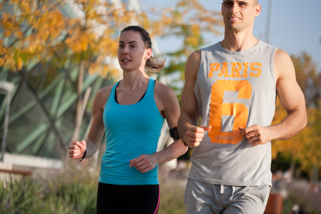 Very fit couple having running fun outdoors.の写真素材