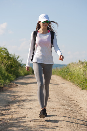 Beautiful young brunette woman hiking in beautiful landscape.の写真素材