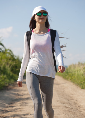 Beautiful young brunette woman hiking in beautiful landscape.の写真素材