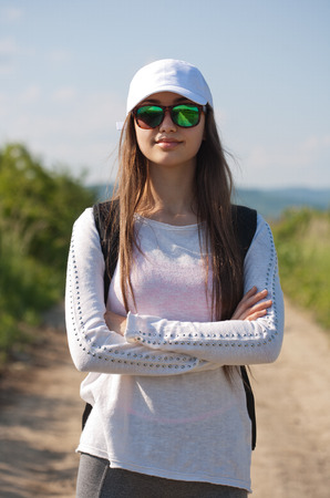Beautiful young brunette woman hiking in beautiful landscape.の写真素材