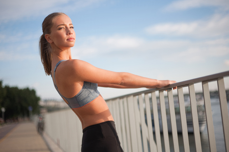 Fit lean blond beauty exercising outdoors in the city.の写真素材