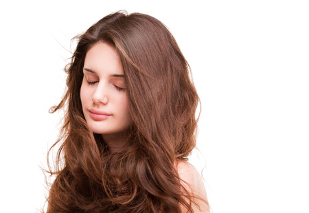 Portrait of a gorgeous young brunette woman with amazing full hair.の写真素材