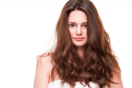 Portrait of a gorgeous young brunette woman with amazing full hair.の写真素材