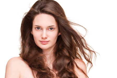 Portrait of a gorgeous young brunette woman with amazing full hair.の写真素材