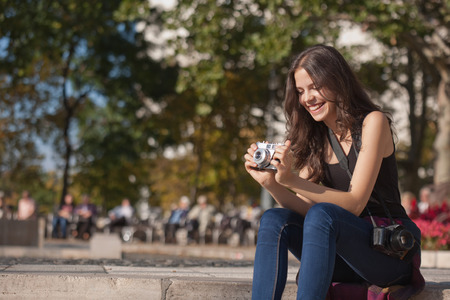 Pretty young photographer girl sporting both digital and analog cameras.の写真素材