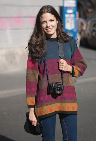 Cute young photographer girl out in the city.の写真素材