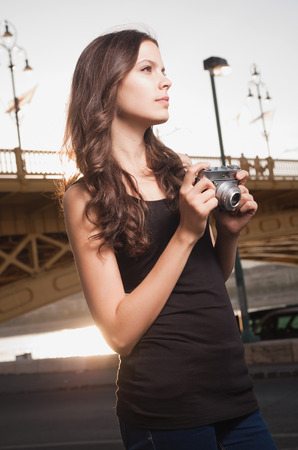 Beautiful young woman photographing the city.の写真素材