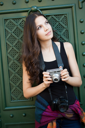 Beautiful young woman photographing the city.の写真素材