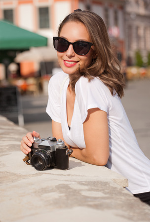 Gorgeous young brunette woman using analog camera.の写真素材