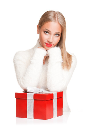 Portrait of a beautiful blond christmas woman with gift box.の写真素材