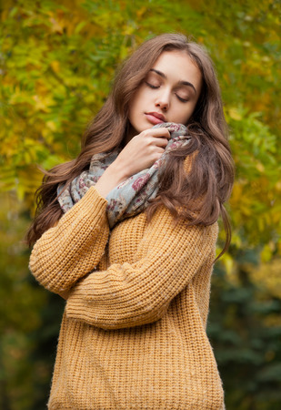 Outdoors portrait of a brunette autumn fashion beauty.の写真素材