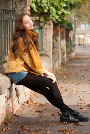 Outdoors portrait of a brunette autumn fashion beauty.の写真素材