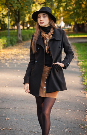Portrait of a young brunette beauty in autumn clothes.の写真素材