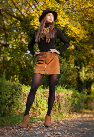 Portrait of a young brunette beauty in autumn clothes.の写真素材