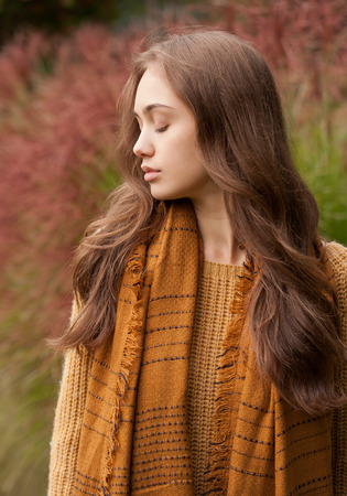 Outdoors portrait of a brunette autumn fashion beauty.の写真素材