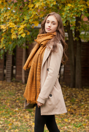 Portrait of a young brunette beauty in autumn clothes.の写真素材