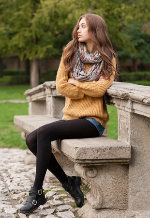 Portrait of a young brunette beauty in autumn clothes.の写真素材
