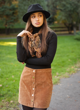 Portrait of a young brunette beauty in autumn clothes.の写真素材
