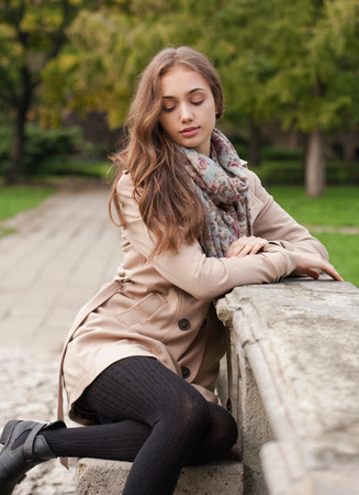 Portrait of a young brunette beauty in autumn clothes.の写真素材