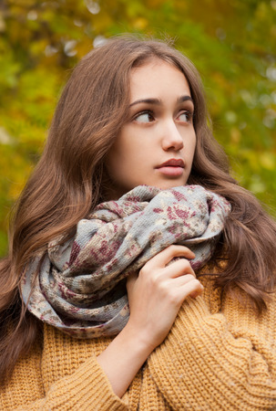 Portrait of a young brunette beauty in autumn clothes.の写真素材