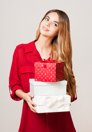 Portrait of a gorgeous young woman with decorative gift boxes.の写真素材