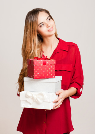 Portrait of a beautiful young woman with Christmas gift boxes.の写真素材