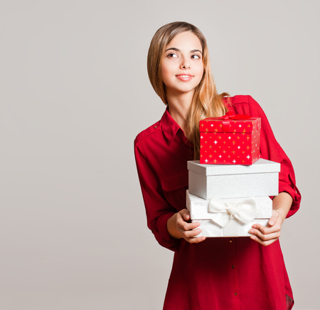 Portrait of a gorgeous young woman with decorative gift boxes.の写真素材