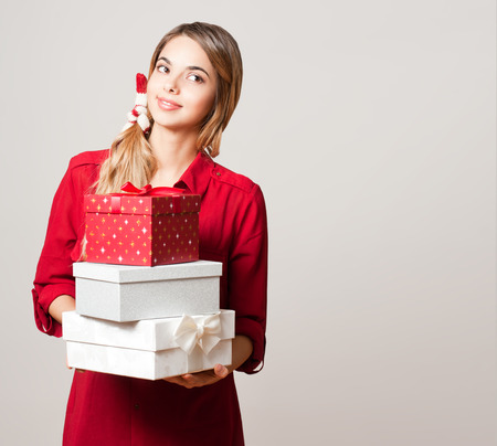 Portrait of a Christmas beauty holding gift boxes.の写真素材