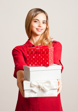 Portrait of a beautiful young woman with Christmas gift boxes.の写真素材