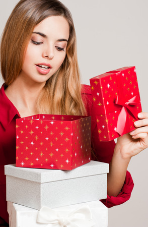 Portrait of a Christmas beauty holding gift boxes.の写真素材