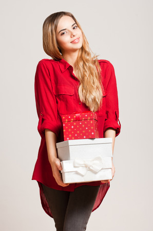 Portrait of a gorgeous young woman with decorative gift boxes.の写真素材