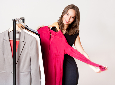 Portrait of a gorgeous young brunette woman shopping clothes.の写真素材