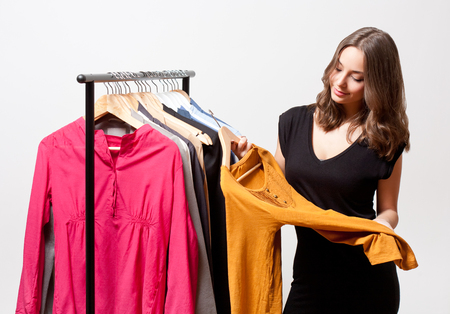 Portrait of a gorgeous young brunette woman shopping clothes.の写真素材