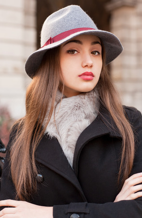 Winter fashion street portrait of a gorgeous young brunette woman.の写真素材