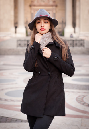 Portrait of a young brunette woman wearing elegant winter fashion.の写真素材