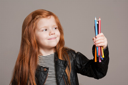 Portrait of beautiful young redhead girl with creative toys.の写真素材