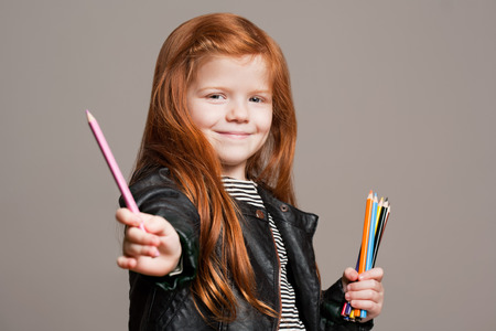 Portrait of beautiful young redhead girl with creative toys.の写真素材