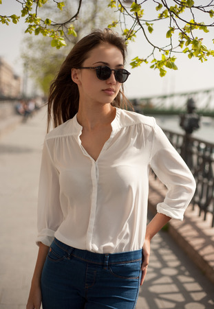 Portrait of a fashionable stylish brunette beauty outdoors.の写真素材
