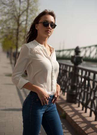 Portrait of a fashionable stylish brunette beauty outdoors.の写真素材