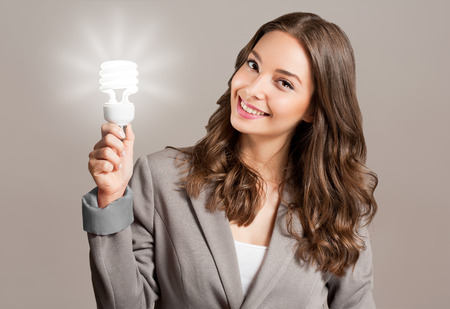 Creative ideas concept, beautiful businesswoman holding glowing symbol.の写真素材