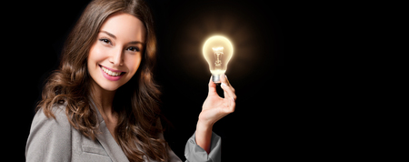 Creative ideas concept, beautiful businesswoman holding glowing symbol.の写真素材